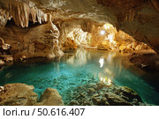 Turquoise water flowing in beautiful caves with stalactites. Стоковое AI-изображение, AI-художник Иван Рябоконь / Фотобанк Лори