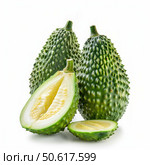 Three spiny bitter gourds, showing one cut open and sliced. Стоковое AI-изображение, AI-художник Иван Рябоконь / Фотобанк Лори