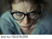 Young woman wearing glasses frowning and showing negative emotions. Стоковое AI-изображение, AI-художник Иван Рябоконь / Фотобанк Лори