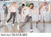 Young girl practicing hip hop slide moves in training hall. Стоковое фото, фотограф Яков Филимонов / Фотобанк Лори