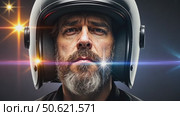 Casually dressed sad looking man in a large helmet with bright stars and galaxies projected on the shield and behind his back with white background. Стоковое AI-видео, аниматор Sergey Grishin / Фотобанк Лори