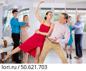 Couple performing elegant support while dancing Viennese waltz in choreography class. Стоковое фото, фотограф Яков Филимонов / Фотобанк Лори