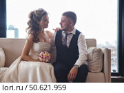 Romantic Moment Between a Couple in Elegant Wedding Attire Captured in a Stylish Indoor Setting. Стоковое фото, фотограф Aleksandr Golubev / Фотобанк Лори