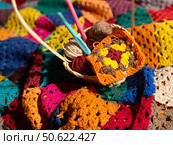 Crochet granny square, clews and hook on crochet blanket background photo. Стоковое фото, фотограф Елена / Фотобанк Лори