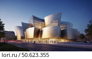 Walt disney concert hall glowing at twilight with people walking nearby. Стоковое AI-изображение, AI-художник Юрий Поздников / Фотобанк Лори
