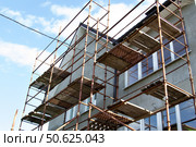 Roof repair of a private residential building. Roof with sheathing for subsequent covering with iron tiles. Стоковое фото, фотограф Жанна Гапанович / Фотобанк Лори