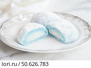 Delicious Japanese moti desserts. Close up. Asian rice daifuku dessert sweet mochi. Cut in half with filling. Traditional dessert mochi ice cream. Colorful rice cake. Fukashi manju. Culinary delights. Стоковое AI-изображение, AI-художник Марина Демидюк / Фотобанк Лори