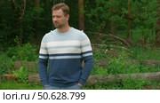 Handsome young man standing outdoors. Male thinking looking around feel happy, calm and serious. Green park background. Guy business employer, businessman manager inspired in nature. Diversity People. Стоковое видео, видеограф Марина Демидюк / Фотобанк Лори
