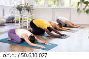 Woman doing restful pose Balasana at group yoga class. Стоковое фото, фотограф Яков Филимонов / Фотобанк Лори