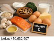 Натюрморт с продуктами, богатыми витамином D: рыба, яйца, молочные изделия, грибы, злаки и овощи на деревянном столе.. Стоковое AI-изображение, AI-художник Башкирова Анна / Фотобанк Лори