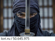 Ninja warrior holding katana in front of face. Стоковое AI-изображение, AI-художник Иван Рябоконь / Фотобанк Лори