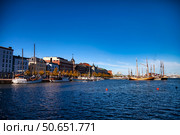 Boats Docked at Katajanokka Harbor With Buildings in Helsinki, Finland, on a Bright Day (2024 год). Редакционное фото, фотограф Aleksandr Golubev / Фотобанк Лори