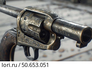 Antique engraved revolver displaying fine craftsmanship. Стоковое AI-изображение, AI-художник Иван Рябоконь / Фотобанк Лори