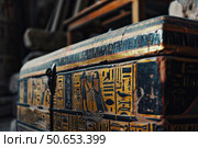 Ancient egyptian wooden chest showing signs of age and decaying in a dusty room. Стоковое AI-изображение, AI-художник Иван Рябоконь / Фотобанк Лори