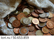 Close up of pile of coins overflowing from burlap bag. Стоковое AI-изображение, AI-художник Иван Рябоконь / Фотобанк Лори