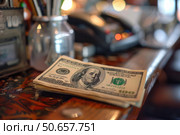 Stack of cash laying on a wooden bar with a blurred background. Стоковое AI-изображение, AI-художник Иван Рябоконь / Фотобанк Лори