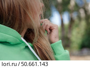 Smiling girl in green tracksuit on street looking at camera. Стоковое фото, фотограф Роготнева Виктория / Фотобанк Лори