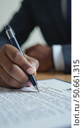 Horizontal closeup image black businessman sitting at desk signing contract. Стоковое AI-видео, аниматор Sergey Grishin / Фотобанк Лори