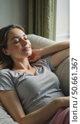 Relaxed calm woman resting breathing fresh air feeling mental balance enjoying wellbeing at home on sofa, satisfied young lady taking pleasure of stress free weekend morning stretching. Стоковое AI-видео, аниматор Sergey Grishin / Фотобанк Лори