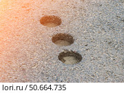 Inspection round holes in asphalt left after checking the thickness and quality of the asphalt. Стоковое фото, фотограф Антон Вахрушев / Фотобанк Лори