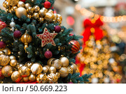 Beautiful Christmas background. Holiday toys on the Christmas tree. Concept of preparing decorations and furnishings for the New Year. New Year's card 2026. Стоковое фото, фотограф Photojuli / Фотобанк Лори