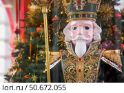 The Nutcracker on the New Year's tree in Moscow. New Year's card 2026. Beautiful Christmas background. Concept of preparing decorations and attire for the New Year. Стоковое фото, фотограф Photojuli / Фотобанк Лори