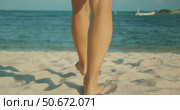 Barefoot woman walks across soft white sand toward the turquoise sea in sunny day. Стоковое видео, видеограф Igor Tichonow / Фотобанк Лори