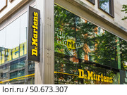 Dr. Martens flagship store with bold yellow signage. London, UK, 11 May 2024. Редакционное фото, фотограф Zydrius Tartenis / Фотобанк Лори
