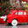 A vintage red Christmas car is carrying a Christmas tree on its roof. Decorated New Year's Moscow. Product delivery concept. Стоковое фото, фотограф Photojuli / Фотобанк Лори