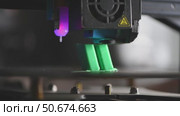 Modern 3d printer creating a green plastic object using innovative technology in a laboratory setting, showcasing the advancements in additive manufacturing. Стоковое видео, видеограф Ольга Ильина / Фотобанк Лори