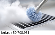 Cleaning a ventilation grill with steam and a brush to remove dust and dirt. Стоковое AI-изображение, AI-художник Katsiaryna Repich / Фотобанк Лори