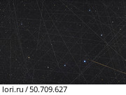 Trails of Earth-orbiting satellites, with a meteor at bottom right. Стоковое фото, фотограф Alan Dyer/Stocktrek Images / ТАСС / Фотобанк Лори