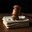 A wooden judge's gavel on a thick stack of banknotes. Стоковое AI-изображение, AI-художник RamA / Фотобанк Лори