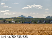 A heavy transport aircraft Antonov An-124 stands at the airport against the backdrop of the mountains. Редакционное фото, фотограф Сергей Сергеев / Фотобанк Лори