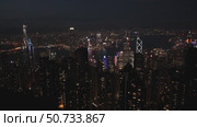 Wonderful aerial view of skyscrapers in downtown and Victoria Harbor in Hong Kong at night. Awesome cityscape. Hong Kong is a popular tourist destination of Asia. Редакционное видео, видеограф Ирина Михайличенко / Фотобанк Лори