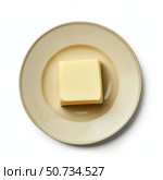 Single piece of butter resting on a plate, overhead view. Стоковое AI-изображение, AI-художник Иван Рябоконь / Фотобанк Лори