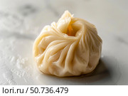 Steamed xiaolongbao dumpling resting on marble surface. Стоковое AI-изображение, AI-художник Иван Рябоконь / Фотобанк Лори