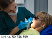 Little Patient Undergoing Checkup at Pediatric Dental Clinic. Стоковое фото, фотограф Aleksandr Golubev / Фотобанк Лори
