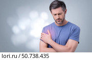 Man suffering from shoulder pain touching affected area. Стоковое AI-изображение, AI-художник Юрий Поздников / Фотобанк Лори