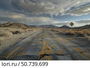 Deteriorated asphalt road leading into desert landscape under cloudy sky. Стоковое AI-изображение, AI-художник Иван Рябоконь / Фотобанк Лори
