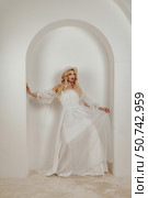 Beauty in White, a Vision in an Archway of Minimal Space. Стоковое фото, фотограф Aleksandr Golubev / Фотобанк Лори