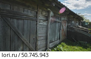 Old weathered wooden barn showing signs of decay in slavic village. Стоковое видео, видеограф Mikhail Davidovich / Фотобанк Лори