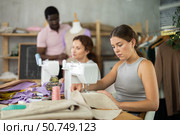 Students participants in coterie practice sewing, other pupil work with mannequin. Стоковое фото, фотограф Яков Филимонов / Фотобанк Лори
