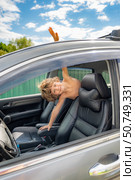 Boy is sitting in a car with his head on the back of the headrest. Стоковое фото, фотограф Дмитрий Брусков / Фотобанк Лори