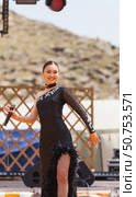 ELANTSY, IRKUTSK REGION, RUSSIA - July 5, 2025: Erdynskie Games – festival of nomadic peoples of Eurasia. Beautiful Buryat girl on an open stage takes part in beauty contest and sings a song. Редакционное фото, фотограф Виктория Катьянова / Фотобанк Лори