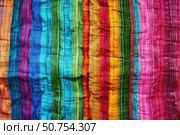 Colorful striped fabric showing vibrant rainbow colors and crinkled texture. Стоковое AI-изображение, AI-художник Иван Рябоконь / Фотобанк Лори