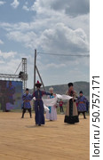ELANTSY, IRKUTSK REGION, RUSSIA - July 5, 2025: Erdynskie Games – festival of nomadic peoples of Eurasia. Vertical video of beautiful girl in national costume with hadak on hands comes on open stage. Редакционное видео, видеограф Виктория Катьянова / Фотобанк Лори