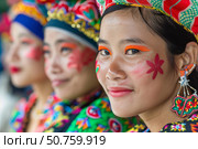 Flower cheeked hmong women wearing traditional colorful clothing and headdress. Стоковое AI-изображение, AI-художник Иван Рябоконь / Фотобанк Лори