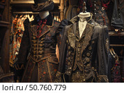 Elegant historical costumes displayed on mannequins in a fashion boutique. Стоковое AI-изображение, AI-художник Иван Рябоконь / Фотобанк Лори