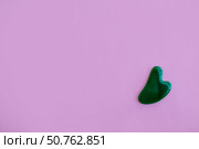 Jade massager on a pink background. Background with copy space. Стоковое фото, фотограф Юлия Николаева / Фотобанк Лори